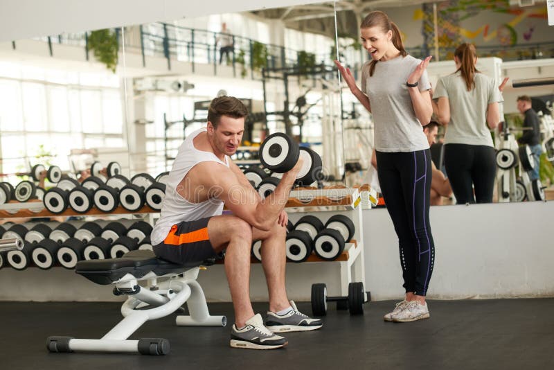 Sportive man flexing muscles with dumbbell. stock image Sportive man flexing muscles with dumbbell. stock image