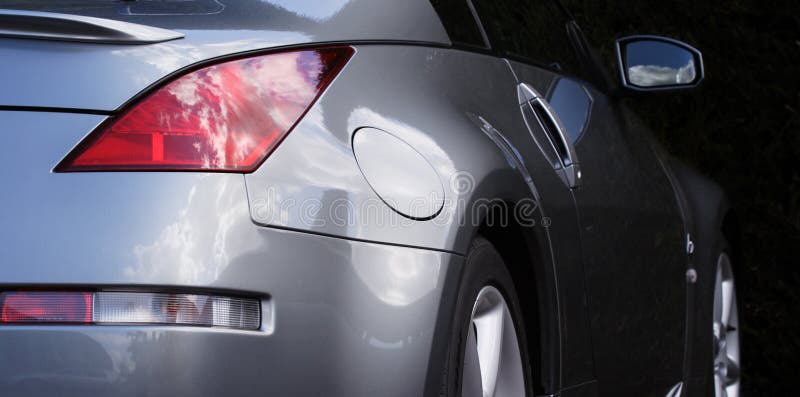 Side of a sports car, highly polished bodywork reflecting the sky. Side of a sports car, highly polished bodywork reflecting the sky