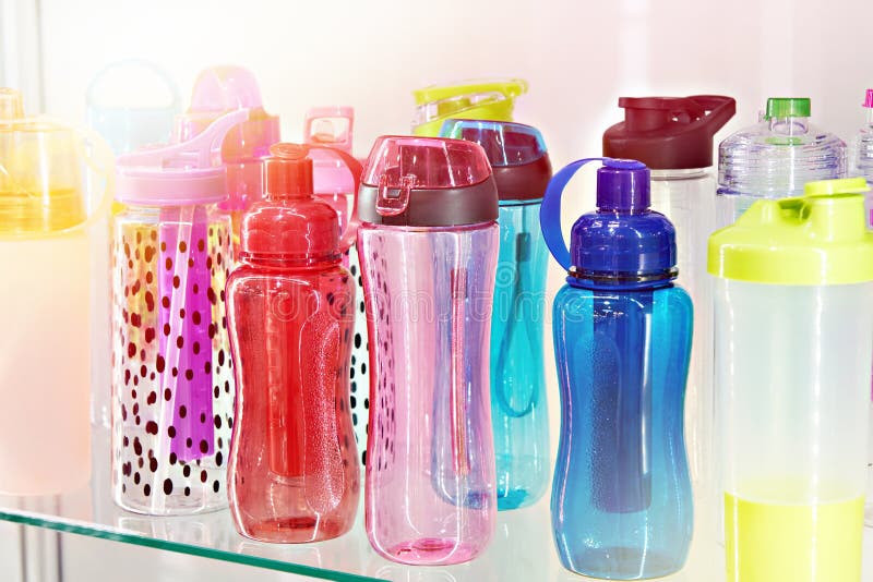 Sports colored plastic bottles for drinking water in shop royalty free stock photo