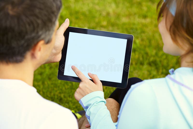 Sports couple using digital tablet