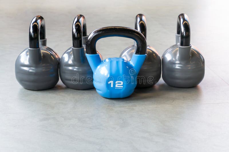 Sports, fitness or bodybuilding concept background. The composition of iron kettlebells on the floor in the gym royalty free stock images Sports, fitness or bodybuilding concept background. The composition of iron kettlebells on the floor in the gym royalty free stock images
