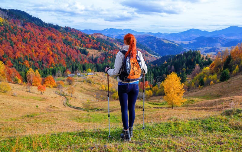 A sports girl with a backpack and tourist sticks. stock photography A sports girl with a backpack and tourist sticks. stock photography