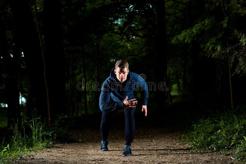 Sports man running at night.