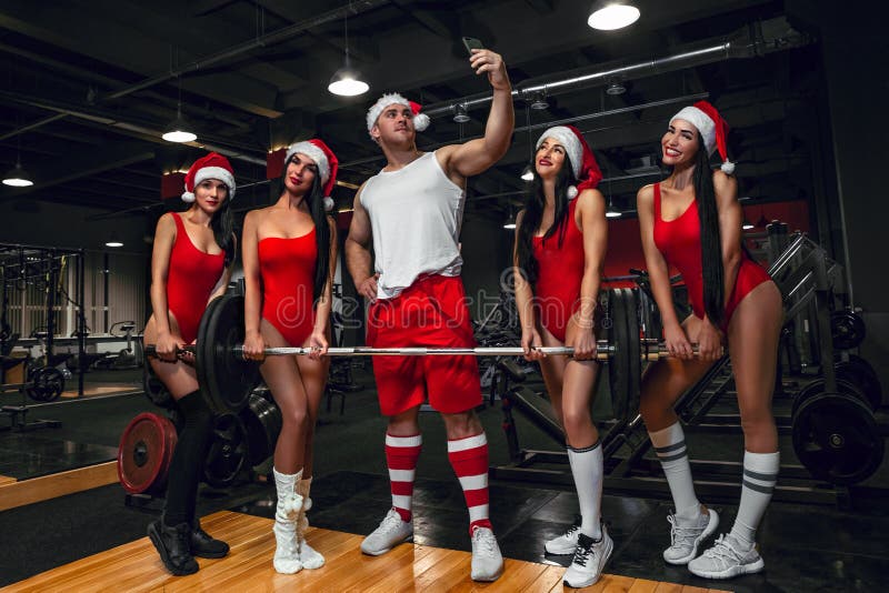 Santa Claus taking selfie by mobile with girls