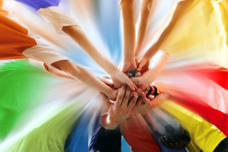 Sports Team All Hands Together. Happy Teammates Standing Together in Circle With All Hands on Deck. Teamwork in Sports Team. Group of Young Players in Colourful Shirts Showing Team Power