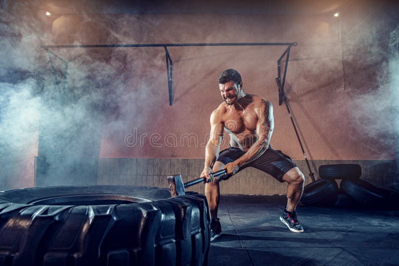 Sports Training for Endurance, Man Hits Hammer. Concept Workout Stock