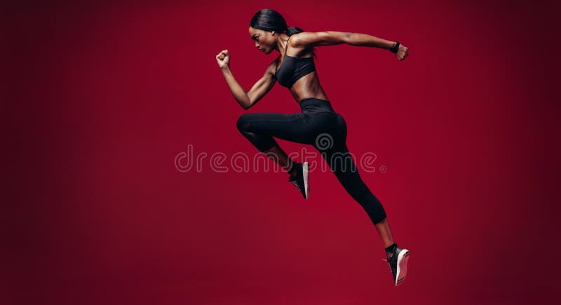 Sports woman running over red background stock photos Sports woman running over red background stock photos