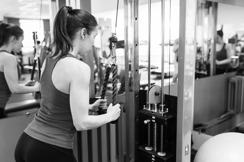 Sports young woman doing exercises in the gym. royalty free stock photos Sports young woman doing exercises in the gym. royalty free stock photos
