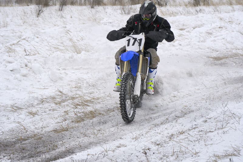 Sportsman racer man fulfills a fast ride on a motorcycle on the road extreme. The race track is very uneven. stock photo Sportsman racer man fulfills a fast ride on a motorcycle on the road extreme. The race track is very uneven. stock photo