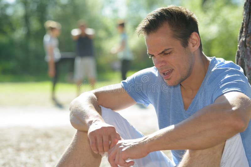 Sportsman resting by tree royalty free stock photos