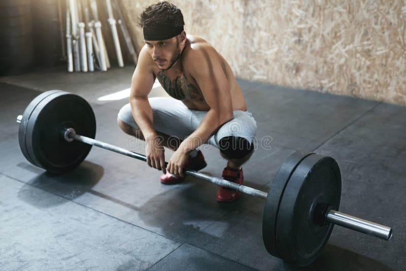 Sportsman Training With Barbell Row At Crossfit Gym. Athletic Man At Workout At Fitness Club. High Resolution