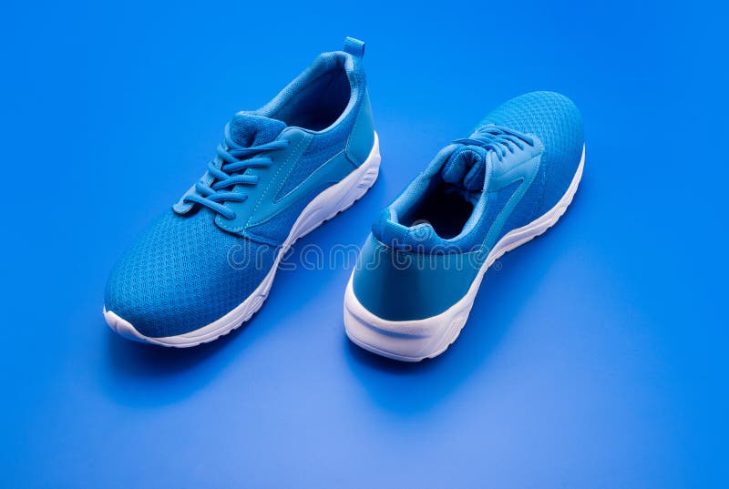 Sporty Blue Sneakers. Shoes on Blue Background. Shoe Store Stock Photo ...