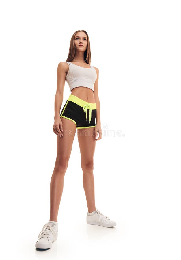 Doing sport. Young active fit woman with long legs listening to music and  doing sport Stock Photo - Alamy