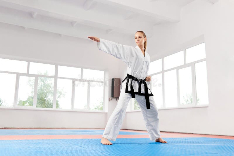 Sporty Karate Woman Against Big Window Standing In Karate Position