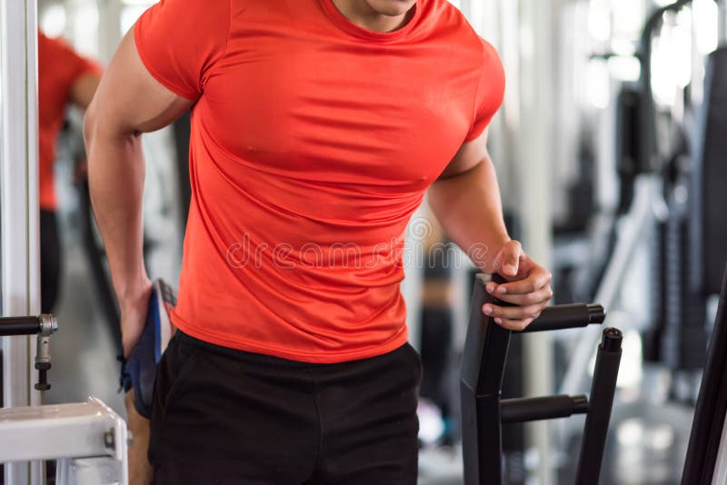 muscle man stretching foot and leg in gym stock photos muscle man stretching foot and leg in gym stock photos