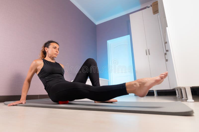 Sporty Slim Caucasian Woman Doing Self Massage On Fitness Mat With