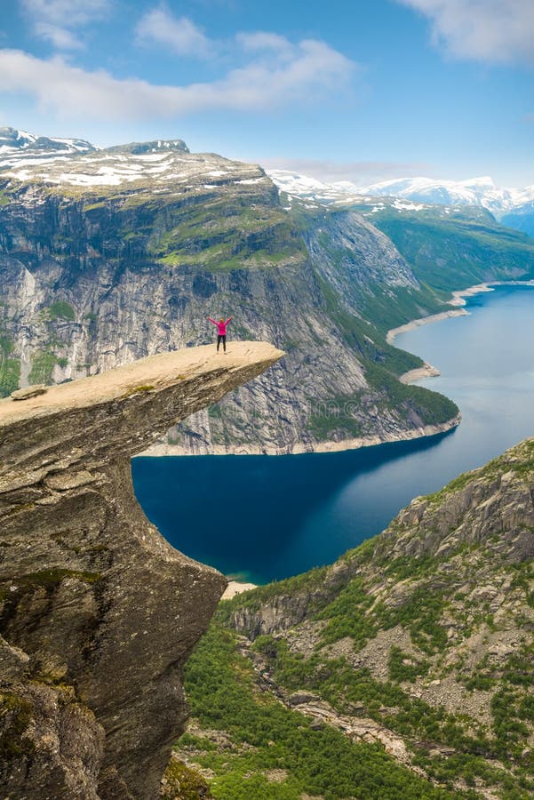 Sporty woman posing on Trolltunga Norway