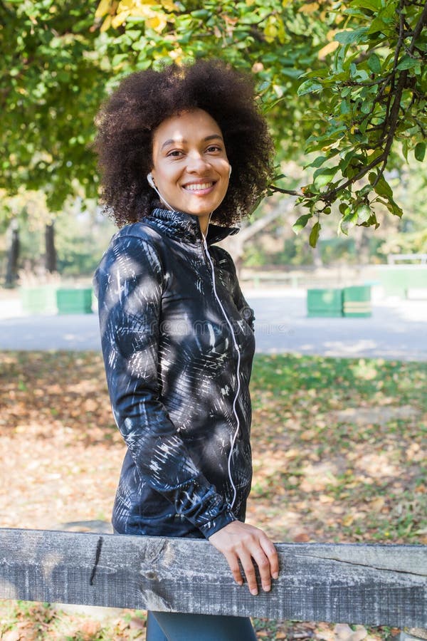 Sporty Woman Relax After Training Listening Music At Park stock photography Sporty Woman Relax After Training Listening Music At Park stock photography