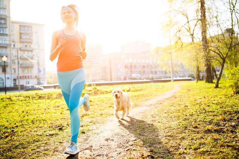 Sporty woman runing with dog