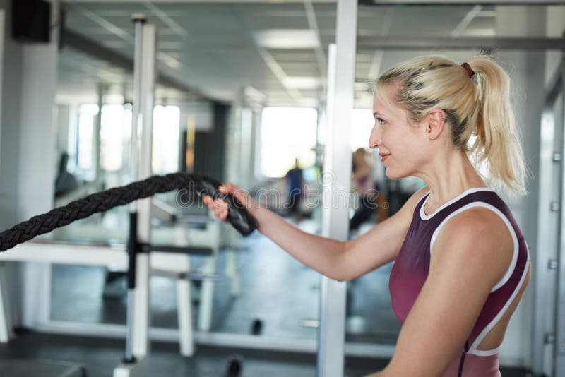 Sporty Young Woman on Battle Rope Workout royalty free stock photo Sporty Young Woman on Battle Rope Workout royalty free stock photo