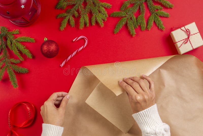 Spostamento di regalo di Natale Il ` s della donna passa la scatola del regalo di Natale dell'imballaggio in carta del mestiere immagini stock Spostamento di regalo di Natale Il ` s della donna passa la scatola del regalo di Natale dell'imballaggio in carta del mestiere immagini stock