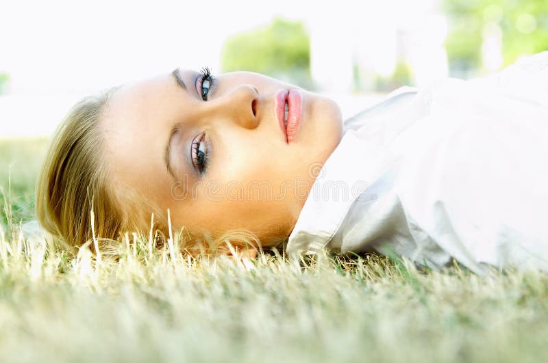 Young business woman relaxing on meadow. Young business woman relaxing on meadow