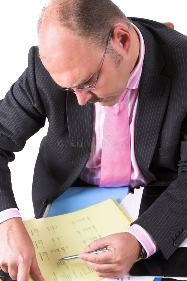 Businessman carefully checking the content of his documents. Businessman carefully checking the content of his documents