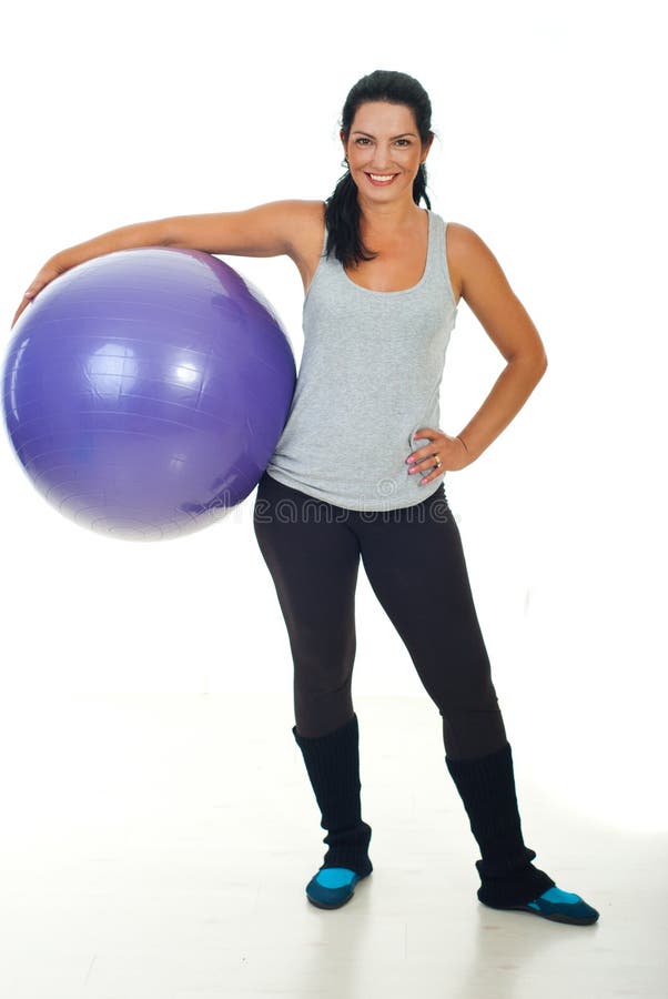 Happy fitness trainer woman holding pilates ball and smiling. Happy fitness trainer woman holding pilates ball and smiling