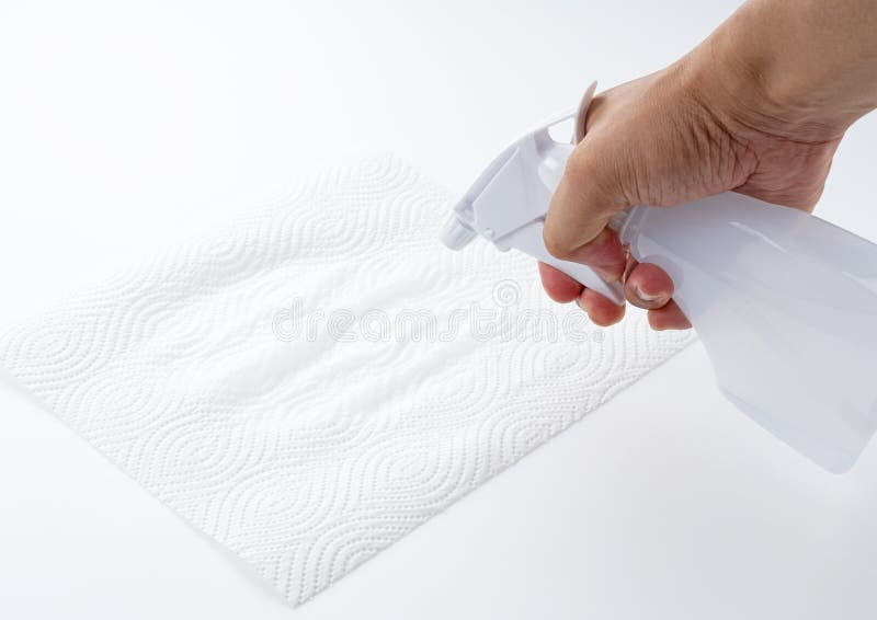 Spray detergent on kitchen paper with a spray bottle