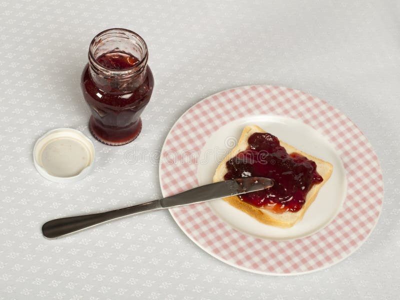 Spread jam on bread stock image. Image of food, hand 28379647