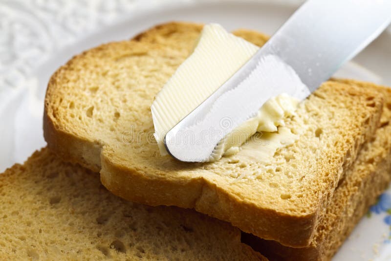 Spreading butter on bread stock photo. Image of piece - 19317562