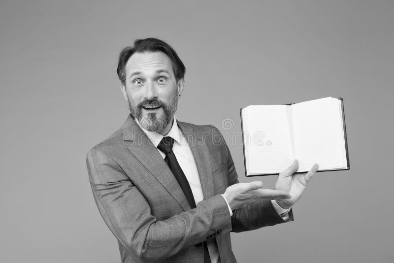Spreading knowledge. happy man found what he was looking for. businessman is amazed to see inside of book about success royalty free stock photos