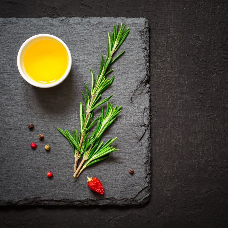 Sprigs of Rosemary and Olive Oil on a Cutting Board Stock Photo Image