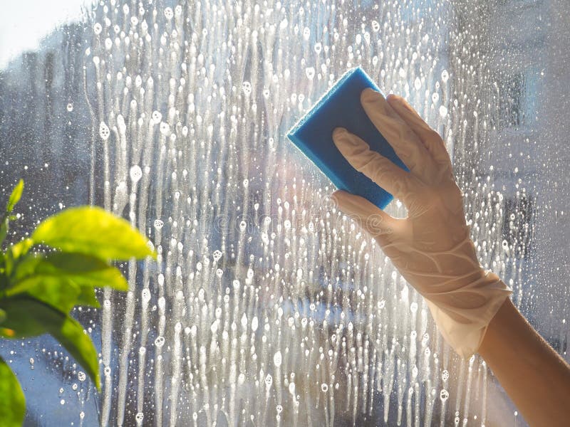 Spring cleaning - cleaning windows. Women`s hands wash the window, cleaning