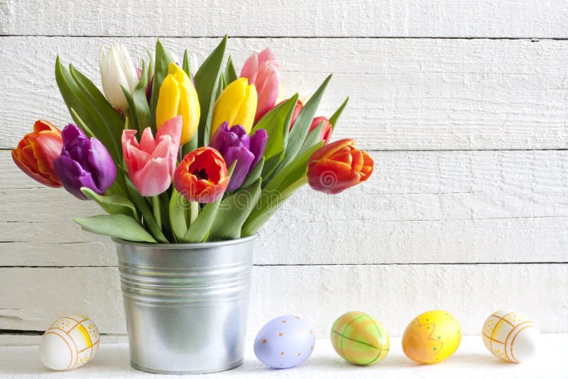 Spring easter tulips in bucket with eggs