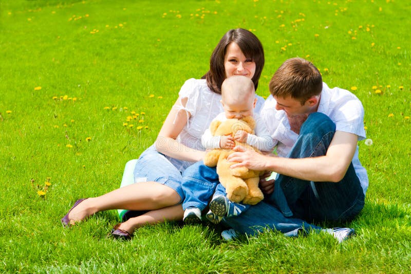 Family sitting on spring grass. Family sitting on spring grass