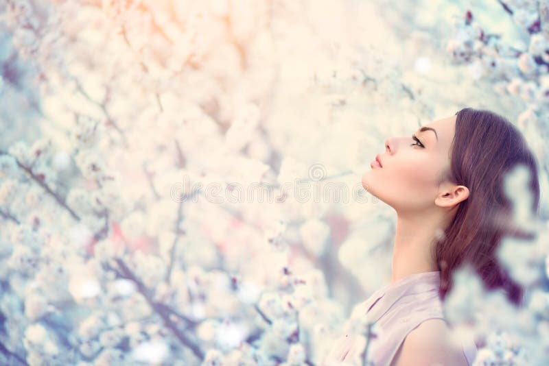 Spring fashion girl in blooming trees