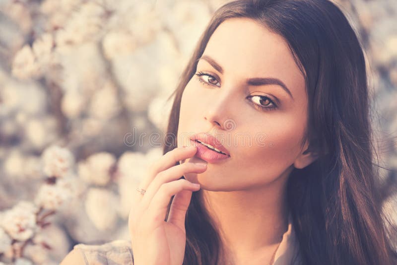 Spring fashion girl outdoors in blooming trees