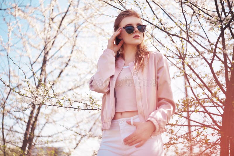 Spring fashion girl outdoors portrait in blooming trees. Beauty Romantic woman in flowers in sunglasses. Sensual Lady. royalty free stock photos Spring fashion girl outdoors portrait in blooming trees. Beauty Romantic woman in flowers in sunglasses. Sensual Lady. royalty free stock photos