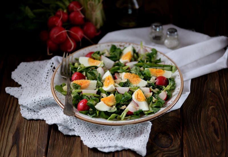 Spring green salad from organic radish, wild garlic with boiled eggs, olive oil and parmesan. stock photos Spring green salad from organic radish, wild garlic with boiled eggs, olive oil and parmesan. stock photos