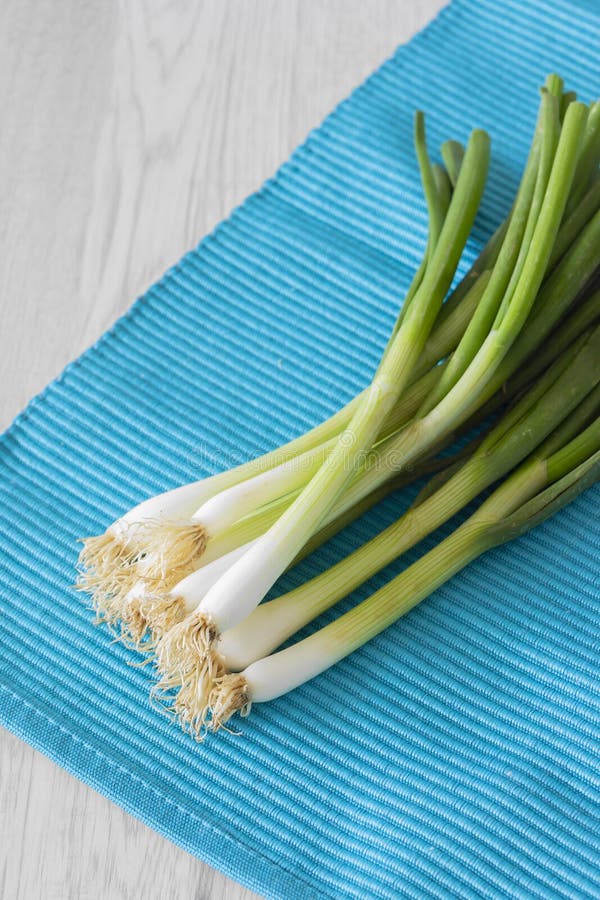 Spring Onions in a Bunch on a Vibrant Blue Placemat Stock Image Image of grey, close 147975807
