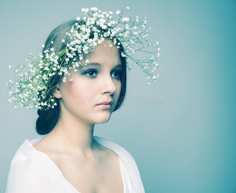 Spring portrait girl with wreath of flowers