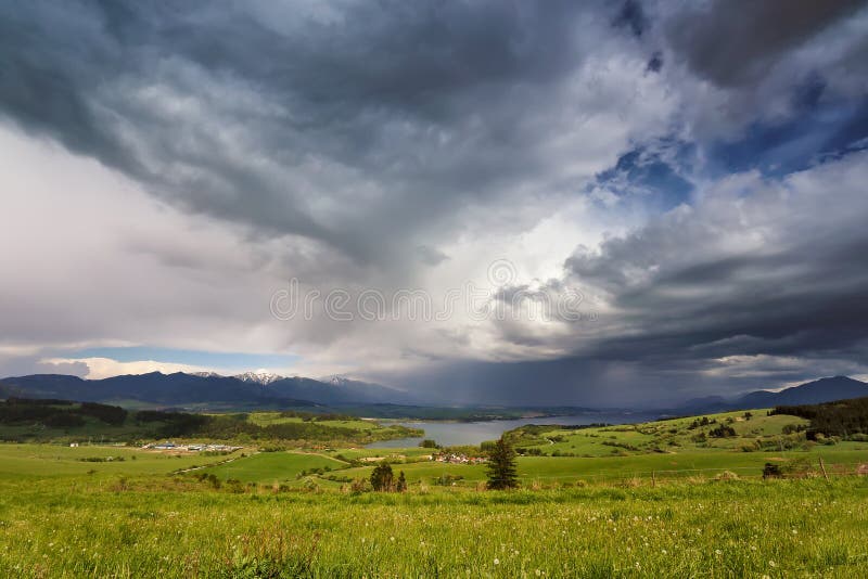 Spring rain and storm in mountains. Green spring hills of Slovak