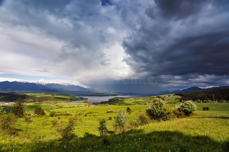 Spring rain and storm in mountains. Green spring hills of Slovak