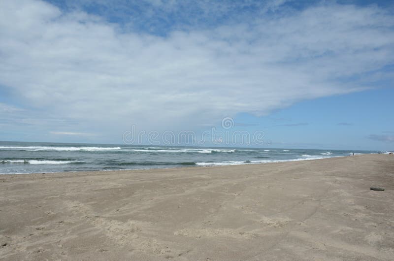 Scenic spring vista on Siletz Bay Beach, pacific ocean and a partly cloudy sky, along the prominent Oregon central coast. Scenic spring vista on Siletz Bay Beach, pacific ocean and a partly cloudy sky, along the prominent Oregon central coast.