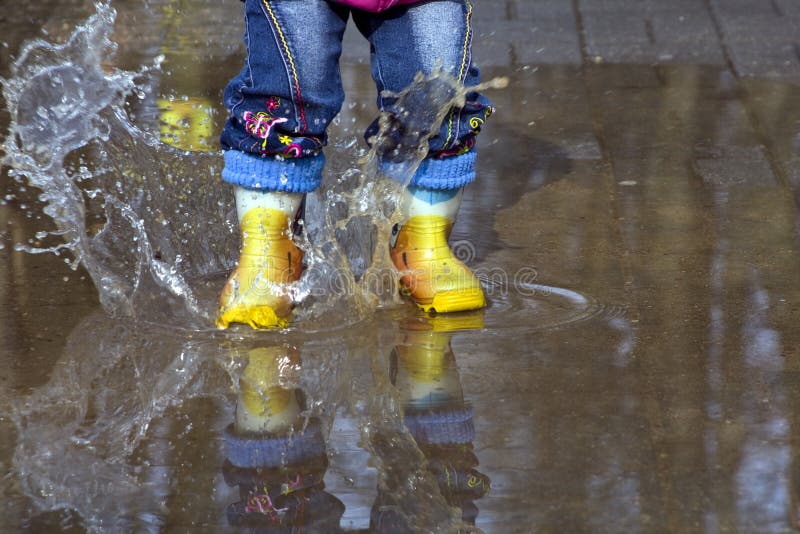 Spring. Child Splashing in Puddle. Spring. Child Splashing in Puddle