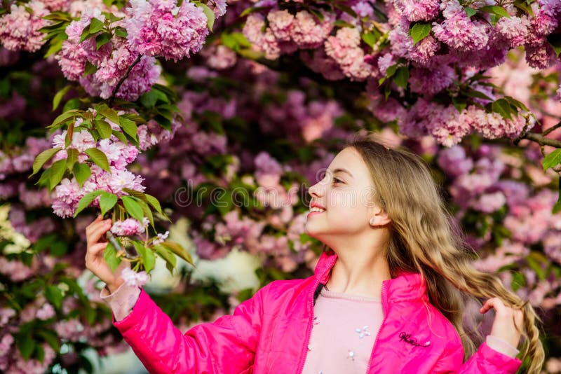It is spring time.. Natural cosmetics for skin. small girl child in spring flower bloom. happy girl in cherry flower royalty free stock photos It is spring time.. Natural cosmetics for skin. small girl child in spring flower bloom. happy girl in cherry flower royalty free stock photos