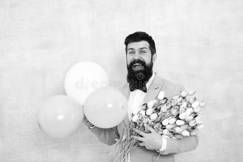 It is spring time. womens day. Formal mature businessman love date with flowers. Happy Birthday. bearded man in bow tie royalty free stock photos It is spring time. womens day. Formal mature businessman love date with flowers. Happy Birthday. bearded man in bow tie royalty free stock photos