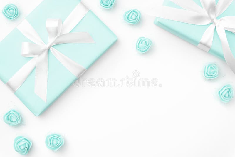 Springtime layout turquoise gift box and rose flowers top view for 8 March Women day copy space isolated on white background. royalty free stock photography Springtime layout turquoise gift box and rose flowers top view for 8 March Women day copy space isolated on white background. royalty free stock photography