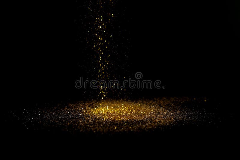 Sprinkle gold dust on a black background with copy space. Shimmering gold glitter texture stock images, royalty-free photos and pictures